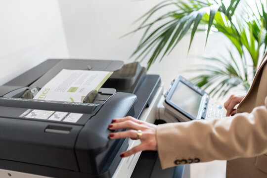 Office worker using a modern multifunction printer