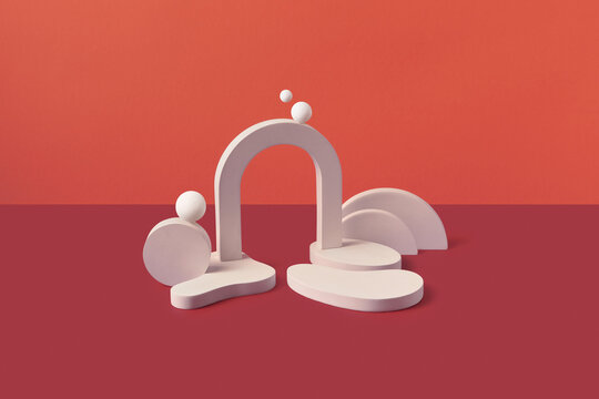 Sculptural white shapes including spheres and arches in studio