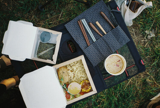 Take-away food and chopsticks on a camp table