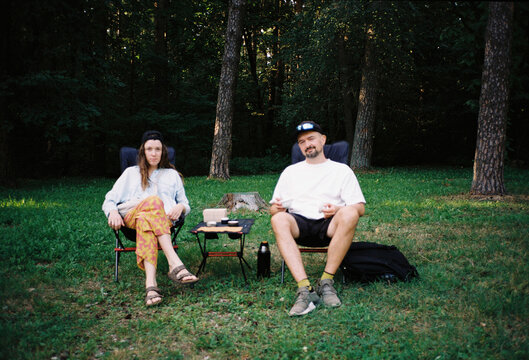 Young couple on camp chairs in the park