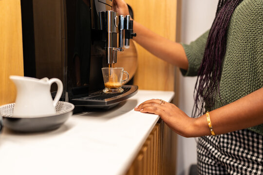 Office worker preparing coffee during break time in coworking space