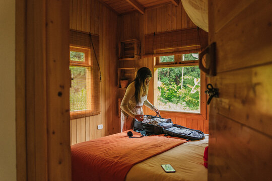 Travel woman packing clothes for traveling