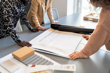 Architects analyzing blueprints and material samples