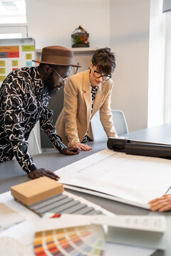 Architects analyzing blueprints and material samples