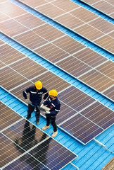 Worker Technicians are working to construct solar panels system on roof. Installing solar photovoltaic panel system. Men technicians walking on roof structure to check photovoltaic solar modules. © ultramansk