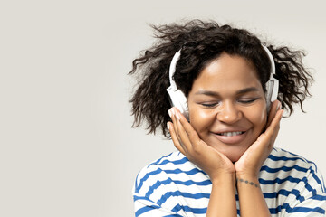 Young African American woman listening to music in headphones