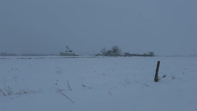 A farm in a field covered by snow