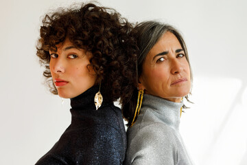 Women posing back to back 