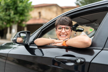 Happy businesswoman smiling while driving her new car