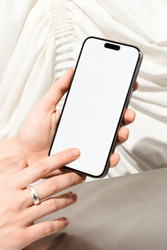 A woman uses a mobile phone with white screen