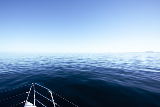 Bow of a yacht with calm ocean.