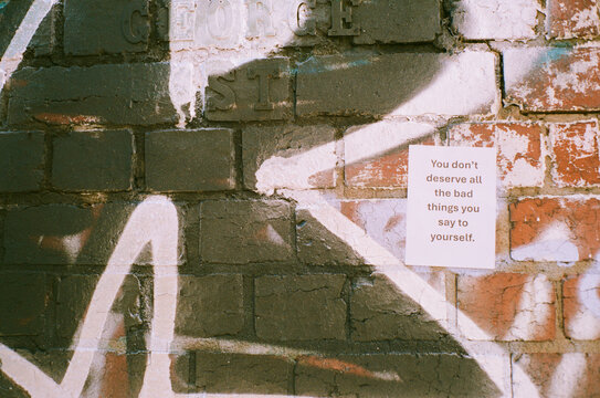 Inspiring message painted on a brick wall in urban setting