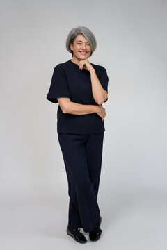 senior businesswoman posing in studio with hand on chin