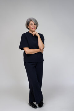 senior businesswoman posing in studio with softbox