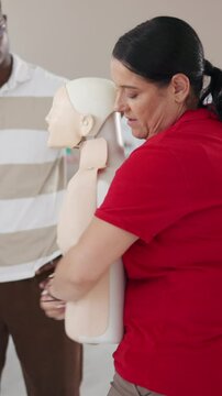 Choking, demonstration and heimlich maneuver with woman in office for instruction or training. Dummy, emergency and rescue with paramedic person teaching course or lesson for first aid practice