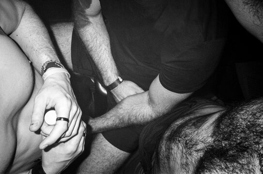 Close-Up of Male Arms and Hands in Nightlife Setting