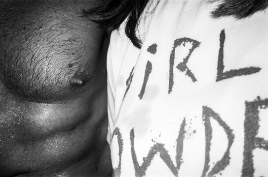 Close-Up of Man's Chest and Woman's Shirt