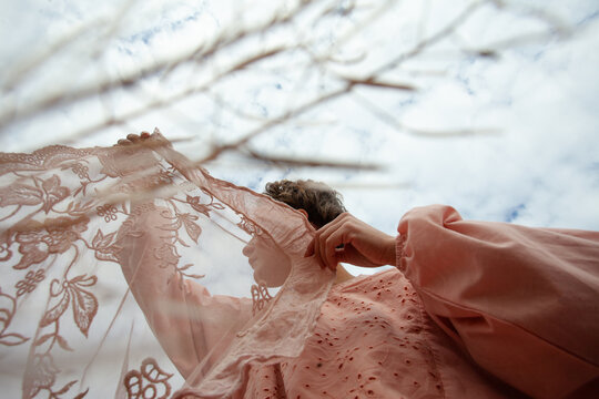 A girl in the pink dress with the lace fabric 