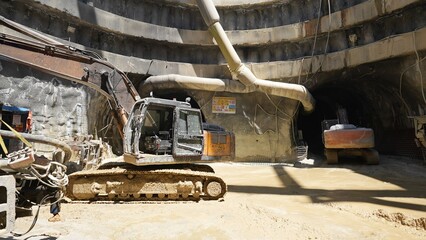 crawler excavators standing in front of tunnels