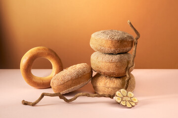 Natural still life with bread on brown and pink background. 