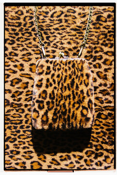 Vintage leopard print purse against animal print backdrop