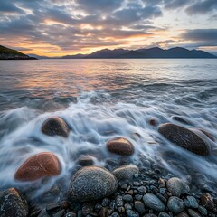 Obraz premium A long exposure of waves washing over smooth rocks