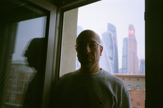 Person by Window with Cityscape View