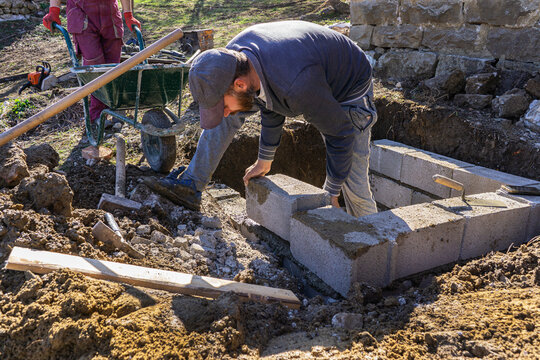 Block masons fit cinder blocks.