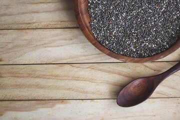 Chia seeds on brown wood background