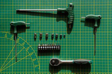 Tools on table with green desk.