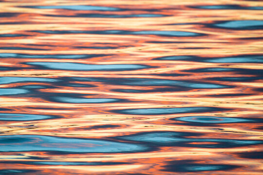 The reflection of the sunset on calm water.