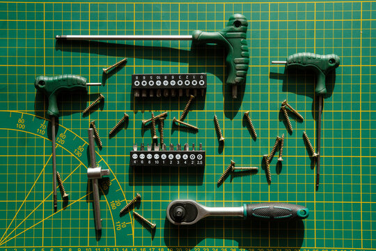 Tools on table with green desk.