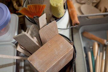 Top view of tools, brushes and materials in an artist's workshop