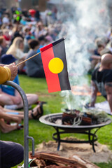 Australian aboriginal flag at the indigenous Smoking Ceremony, meeting and rite at public event