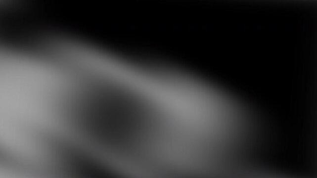 Blurry black, gray and white gradient background. Suitable for backgrounds, overlays, or creative design projects with a modern monochrome aesthetic.
