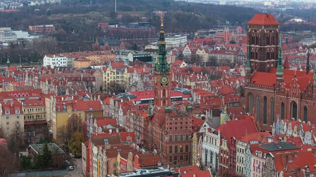 Main Town Hall in Gdansk with St Mary church on the right surrounding gothic architecture buildings on famous Dluga and Mariacka street in the evening, Aerial view