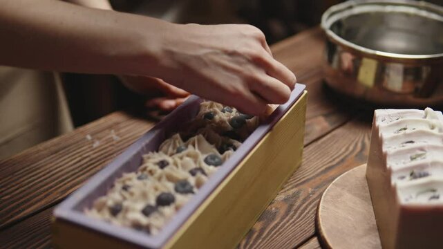 The master soapmaker is decorating natural handmade berry soap. Natural cosmetics. The process of making soap in the workshop