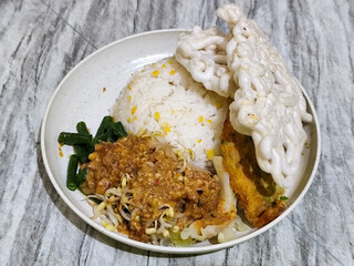 Pecel Rice. A traditional Javanese rice dish consisting of white rice with vegetables, peanut sauce, eggs.