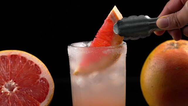 Mexican drink paloma cocktail, garnish with a grapefruit, oled background