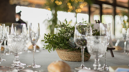 Table with glasses and decoration in a restaurant, during the meal served at a wedding, Spain