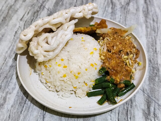 Pecel Rice. A traditional Javanese rice dish consisting of white rice with vegetables, peanut sauce, eggs.