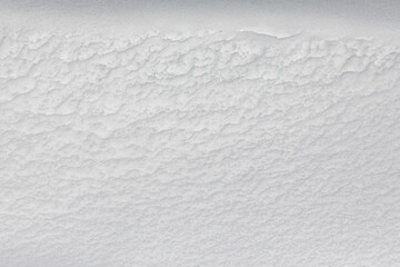 Obraz premium Background Texture of powdery snow, pristine white, intact, in the morning light after a heavy snowfall