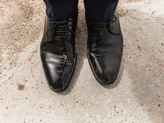 Elegant black men's shoes, dirty with dust and dirt