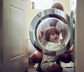 Mother and child doing laundry together in a cozy home setting