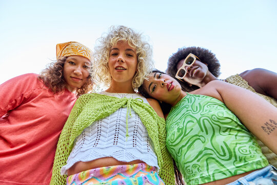 Happy diverse women in trendy outfits
