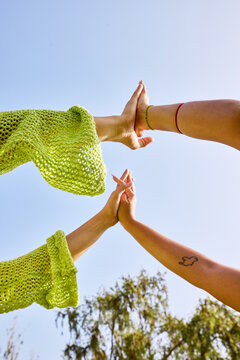 Crop women giving high five