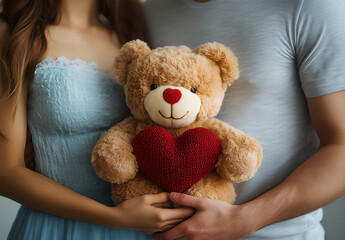 A couple holding a loving teddy bear