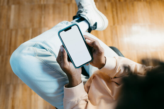 Crop of anonymous man's hands checking smartphone 