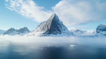 Majestic sharp mountain peak wrapped in swirling clouds and mist