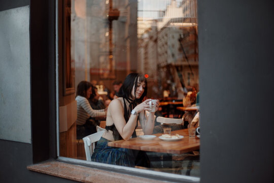 Woman enjoying coffee at cafe
